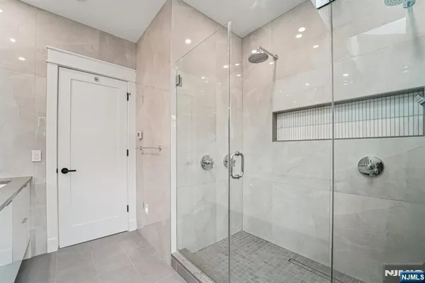 a bathroom with a glass shower door
