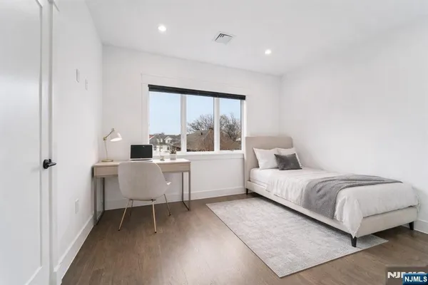 a bedroom with a bed and a large window