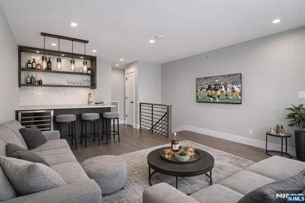 a living room with furniture a rug and kitchen view