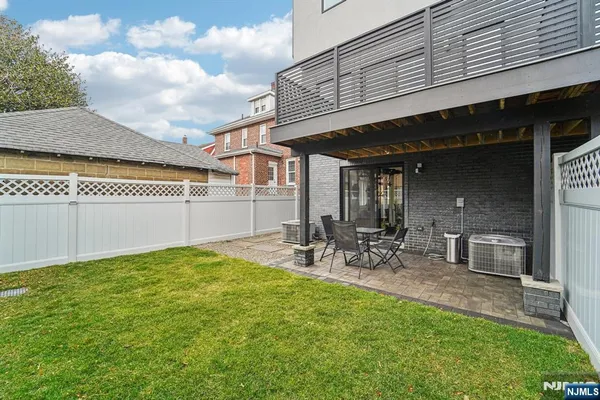 a backyard of a house with table and chairs