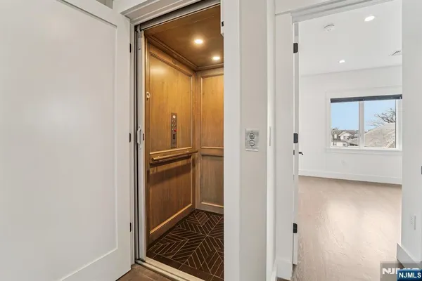 a view of hallway with wooden floor
