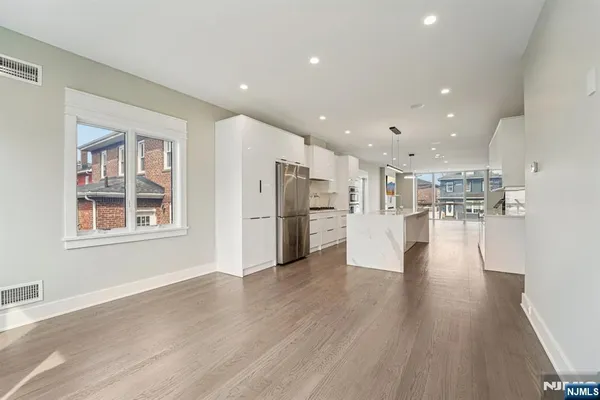 a view of kitchen with stainless steel appliances refrigerator oven and cabinets
