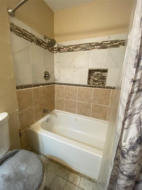 808 North Hughes Street Howe, TX 75459 - Photo 13 of 19 a white bath tub sitting next to a toilet