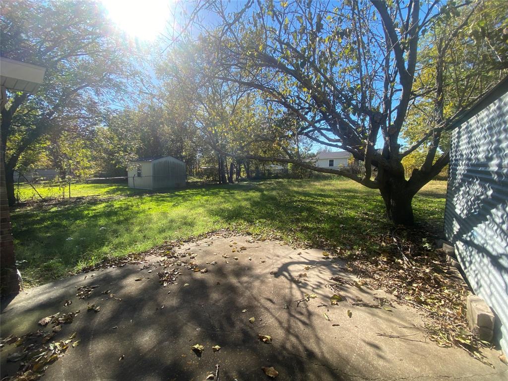 808 North Hughes Street Howe, TX 75459 - Photo 18 of 19 a view of a yard with large trees