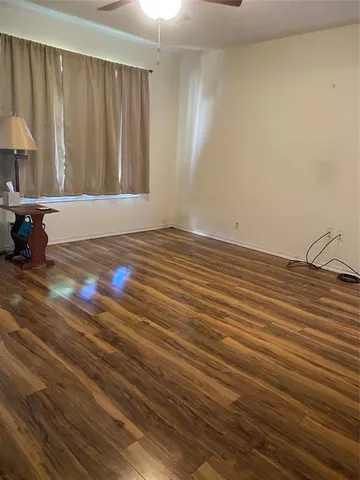 a view of a room with wooden floor and cabinet