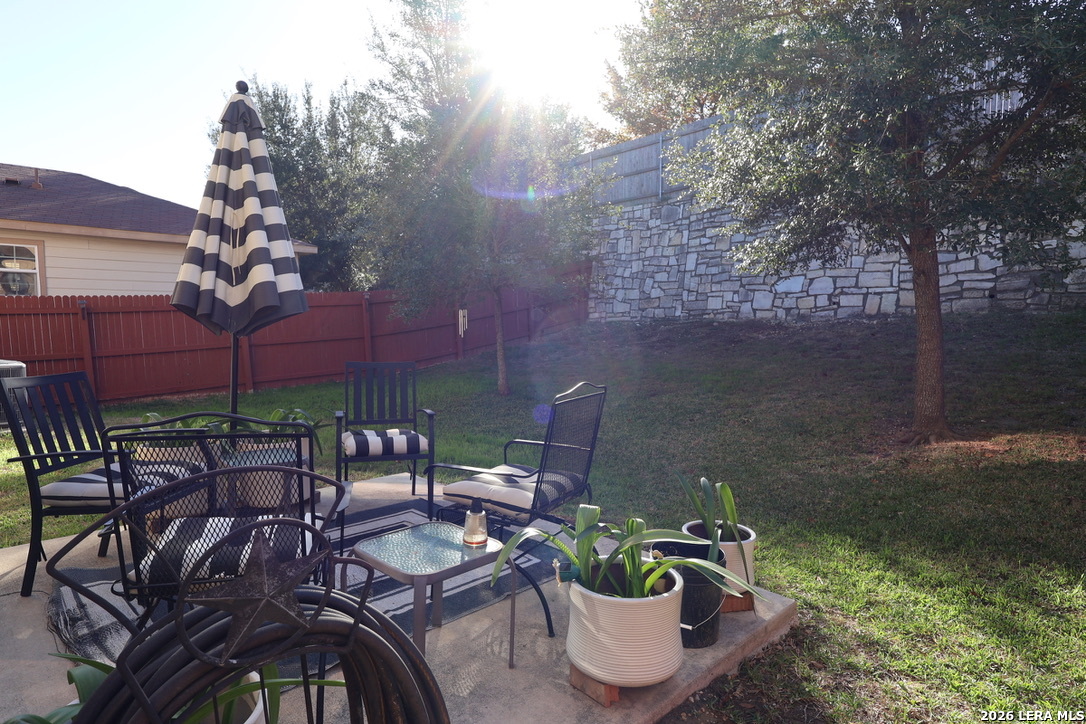 9927 Hawk Village Converse, TX 78109 - Photo 21 of 25 a view of a chairs and table in backyard