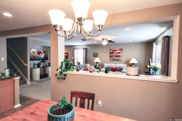 a room with wooden floor and potted plant