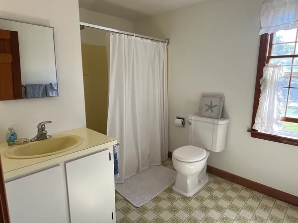 a bathroom with a sink toilet and a mirror