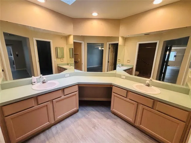 a bathroom with double vanity sinks and a large mirror