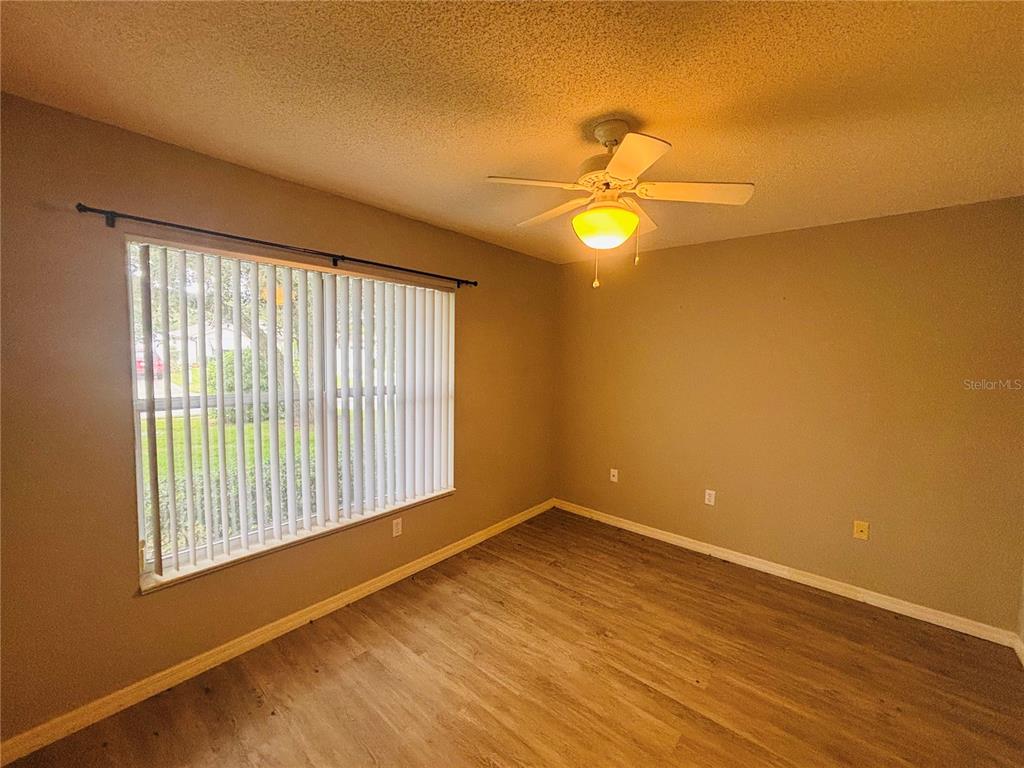 177 North Golf Harbor Path Inverness, FL 34450 - Photo 17 of 27 a view of an empty room with a window and wooden floor