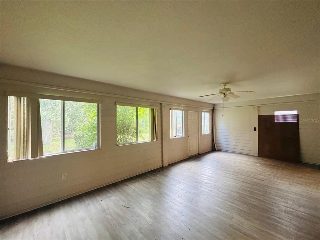 177 North Golf Harbor Path Inverness, FL 34450 - Photo 23 of 27 an empty room with wooden floor and windows