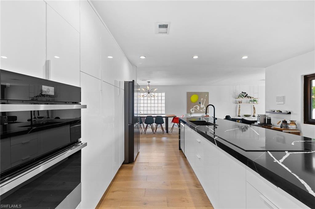 70 Thorncrest Lane Naples, FL 34113 - Photo 12 of 50 a large kitchen with stainless steel appliances lots of counter space and breakfast area