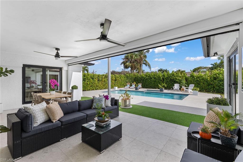 70 Thorncrest Lane Naples, FL 34113 - Photo 36 of 50 a outdoor living space with furniture and a garden