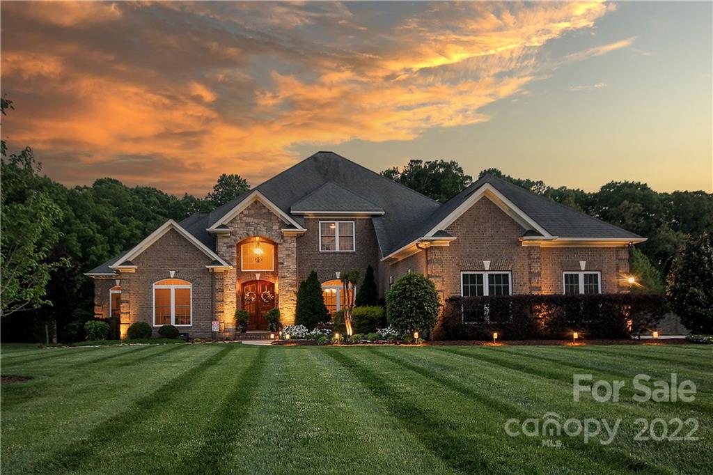 159 Abbington Place, Unit 16 Locust, NC 28097 - Photo 1 of 47 a front view of a house with a garden