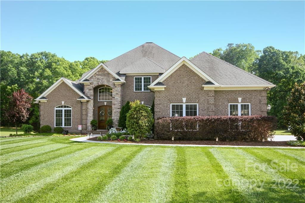 159 Abbington Place, Unit 16 Locust, NC 28097 - Photo 2 of 47 a front view of a house with a yard and trees