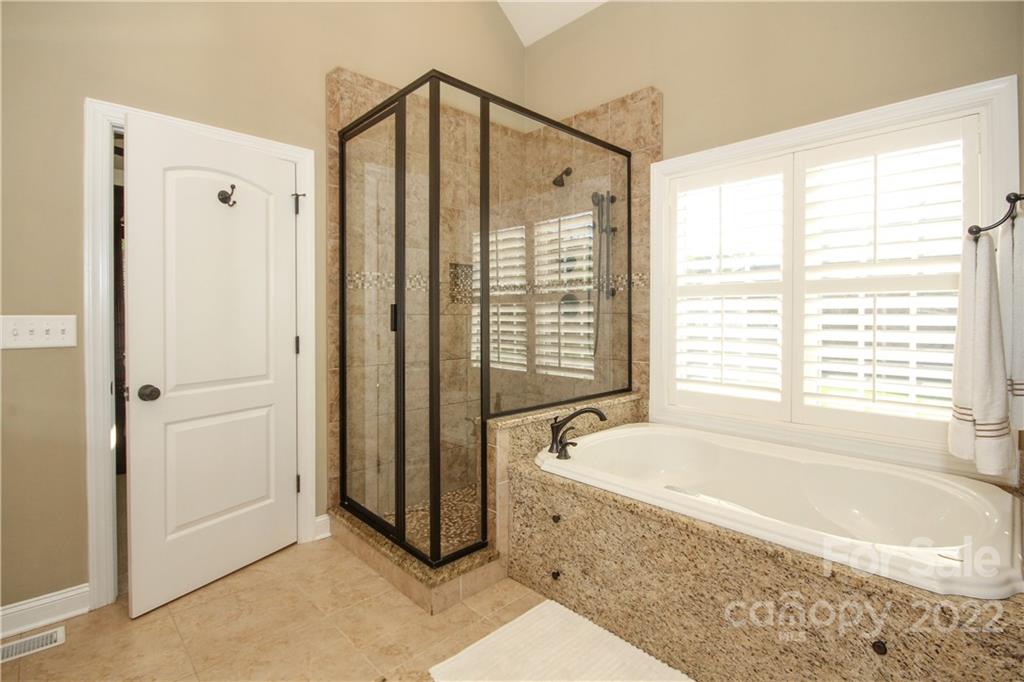 159 Abbington Place, Unit 16 Locust, NC 28097 - Photo 22 of 47 a bathroom with a bathtub and a shower