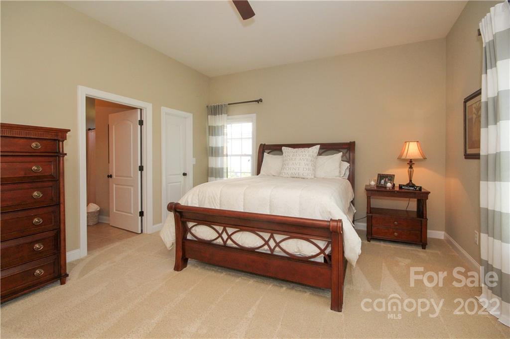 159 Abbington Place, Unit 16 Locust, NC 28097 - Photo 26 of 47 a bedroom with a bed and a dresser