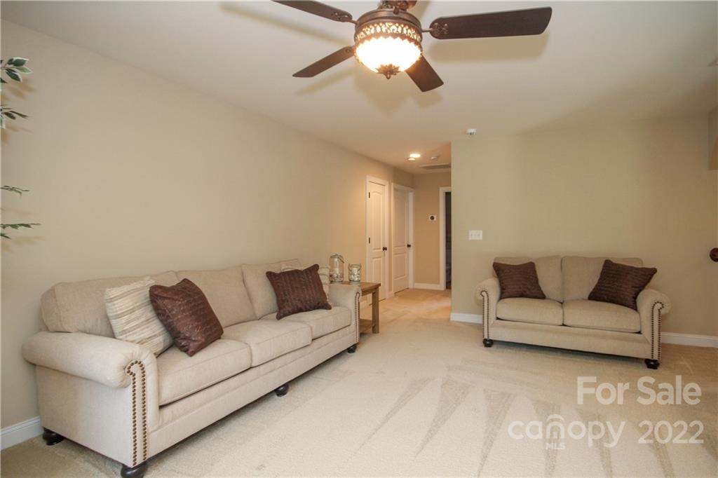 159 Abbington Place, Unit 16 Locust, NC 28097 - Photo 28 of 47 a living room with furniture and a ceiling fan