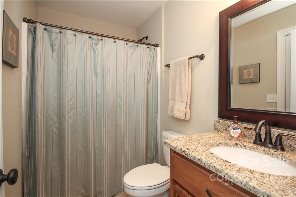 159 Abbington Place, Unit 16 Locust, NC 28097 - Photo 31 of 47 a bathroom with a granite countertop sink toilet and shower
