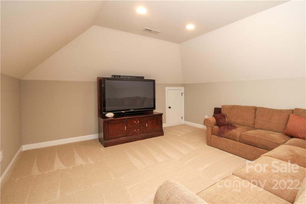 159 Abbington Place, Unit 16 Locust, NC 28097 - Photo 33 of 47 a living room with furniture and a flat screen tv