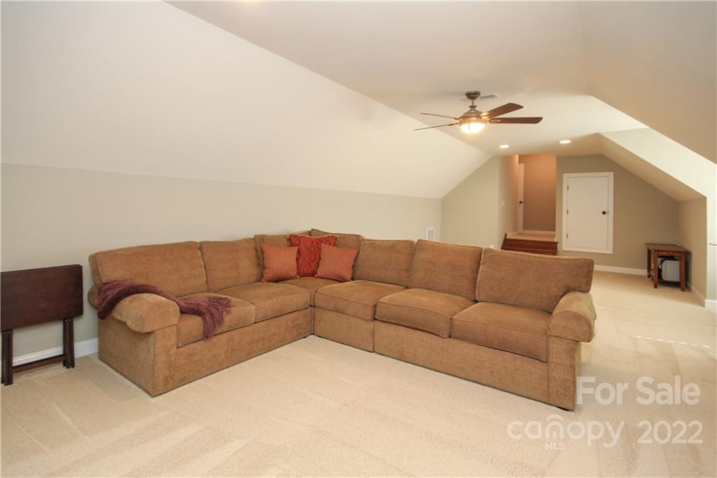 159 Abbington Place, Unit 16 Locust, NC 28097 - Photo 34 of 47 a living room with furniture and a chandelier
