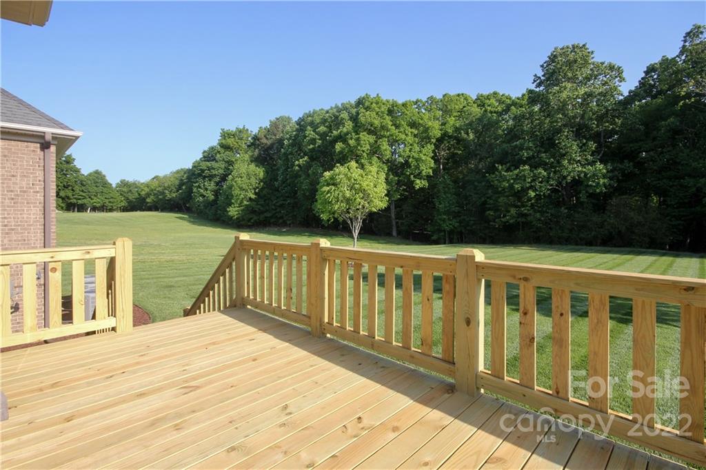 159 Abbington Place, Unit 16 Locust, NC 28097 - Photo 36 of 47 a view of wooden deck and a garden
