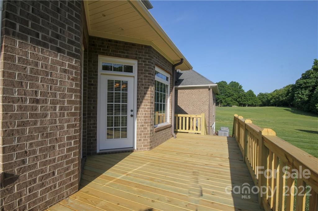 159 Abbington Place, Unit 16 Locust, NC 28097 - Photo 37 of 47 a view of a wooden deck and a yard