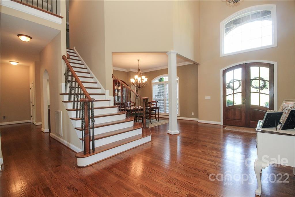 159 Abbington Place, Unit 16 Locust, NC 28097 - Photo 4 of 47 a view of a living room and entryway with wooden floor