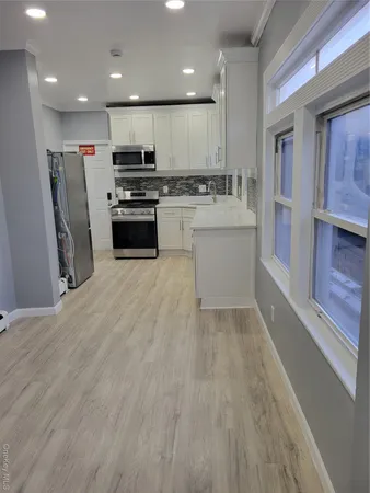 a kitchen with a sink stainless steel appliances and cabinets