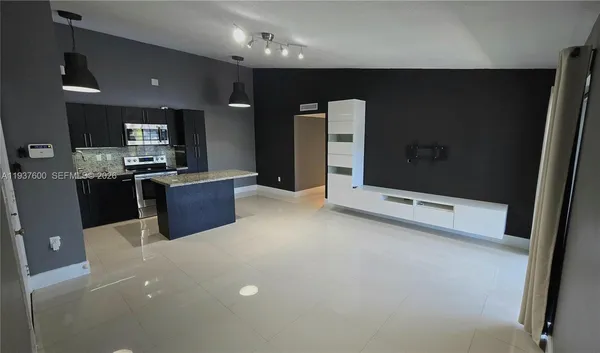 a kitchen with stainless steel appliances a refrigerator sink and stove