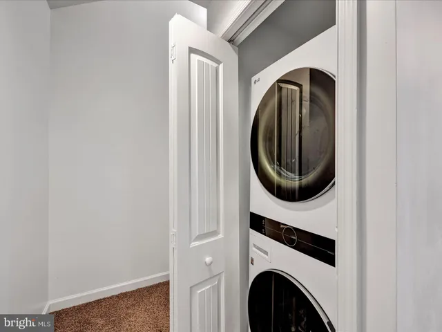 a close view of a utility room with dryer and washer