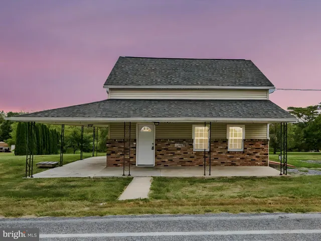 a view of a house with a yard balcony and sitting area