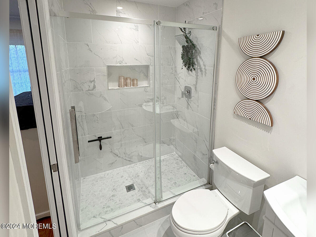 3 Moak Drive Hazlet, NJ 07730 - Photo 15 of 27 a white toilet sitting next to a bathroom sink