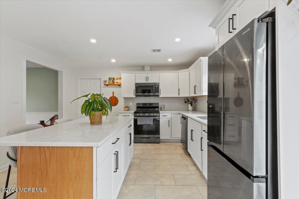 3 Moak Drive Hazlet, NJ 07730 - Photo 9 of 27 a kitchen with kitchen island granite countertop stainless steel appliances and cabinets