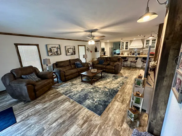 a view of a hallway with workspace and wooden floor