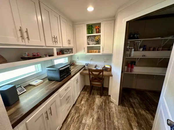 a bedroom with a bed dresser and a window