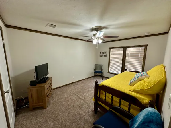 a view of a livingroom with furniture and a window