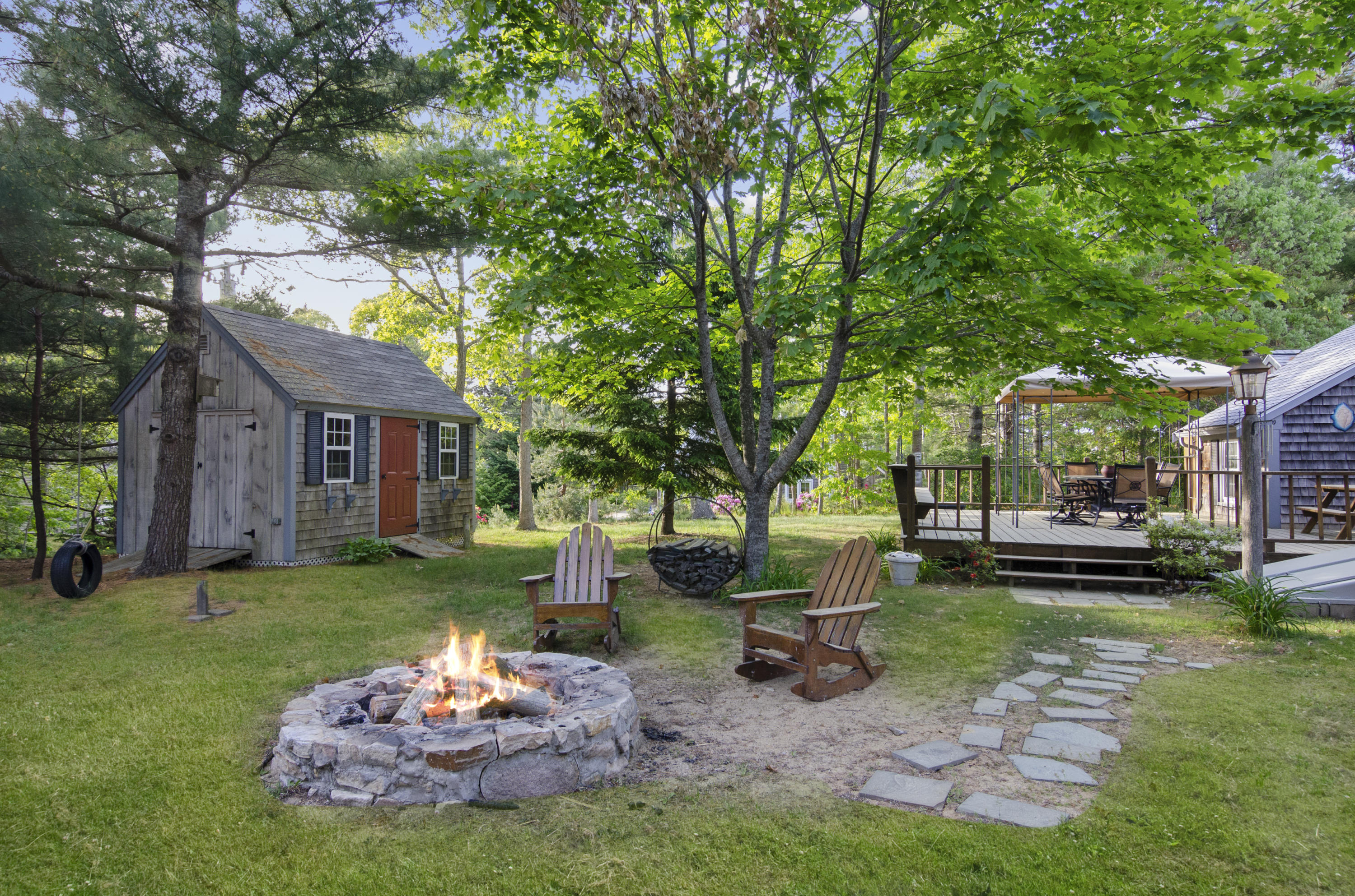 23 Skippers Way Brewster, MA 02631 - Photo 19 of 27 a view of a chair and table in backyard of the house