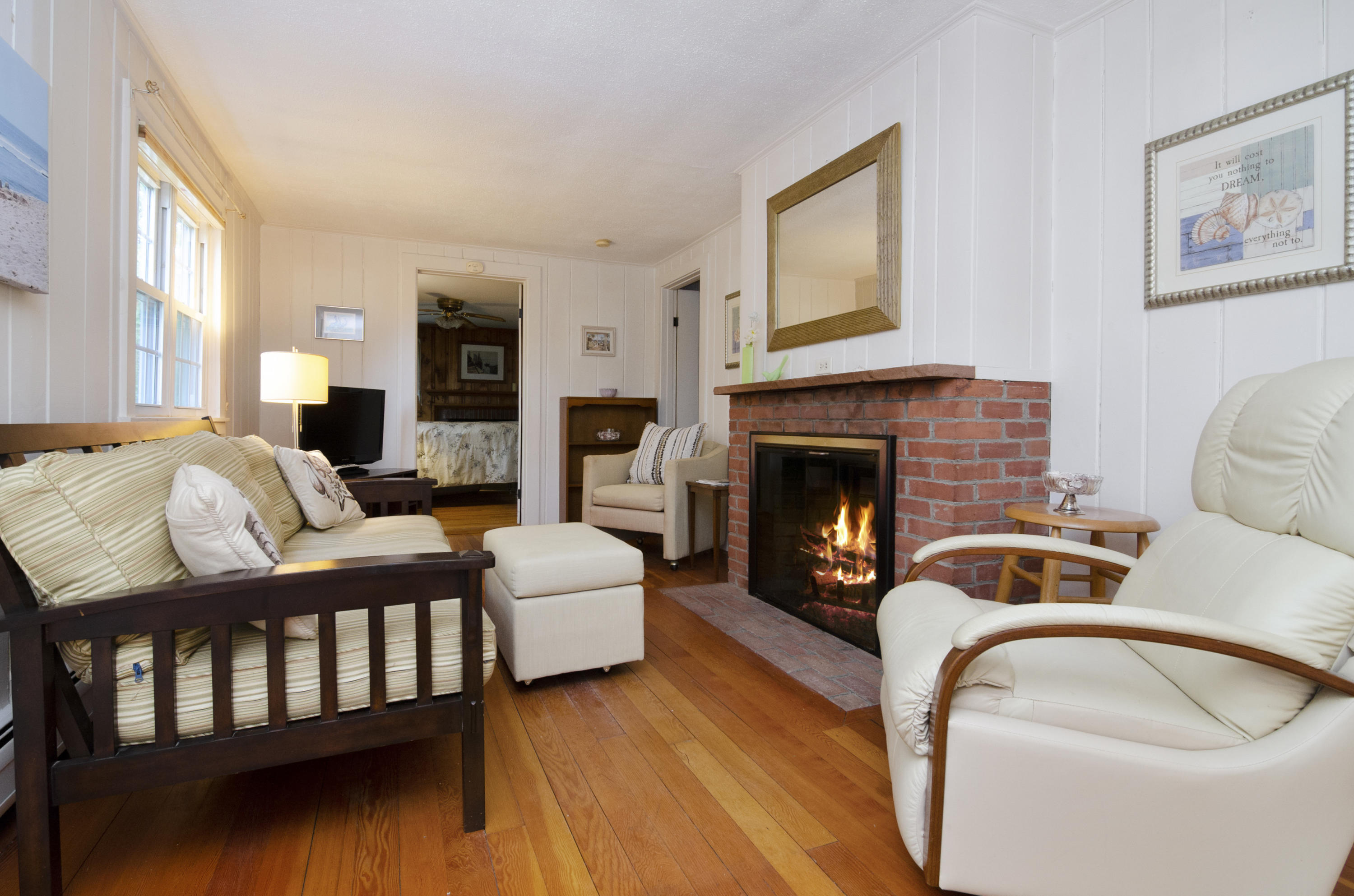 23 Skippers Way Brewster, MA 02631 - Photo 3 of 27 a living room with furniture and a fireplace