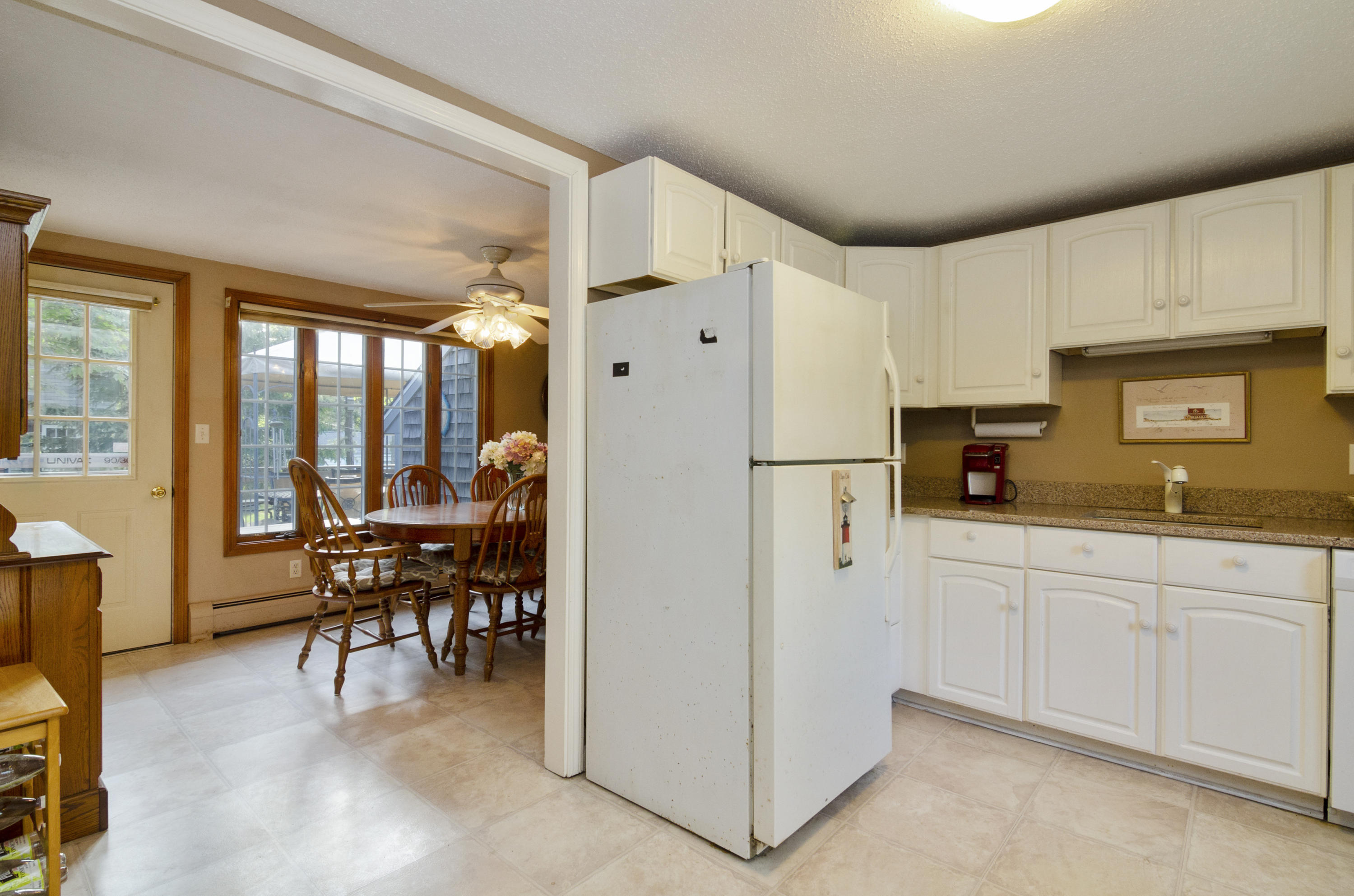 23 Skippers Way Brewster, MA 02631 - Photo 9 of 27 a kitchen with stainless steel appliances a refrigerator a table and chairs