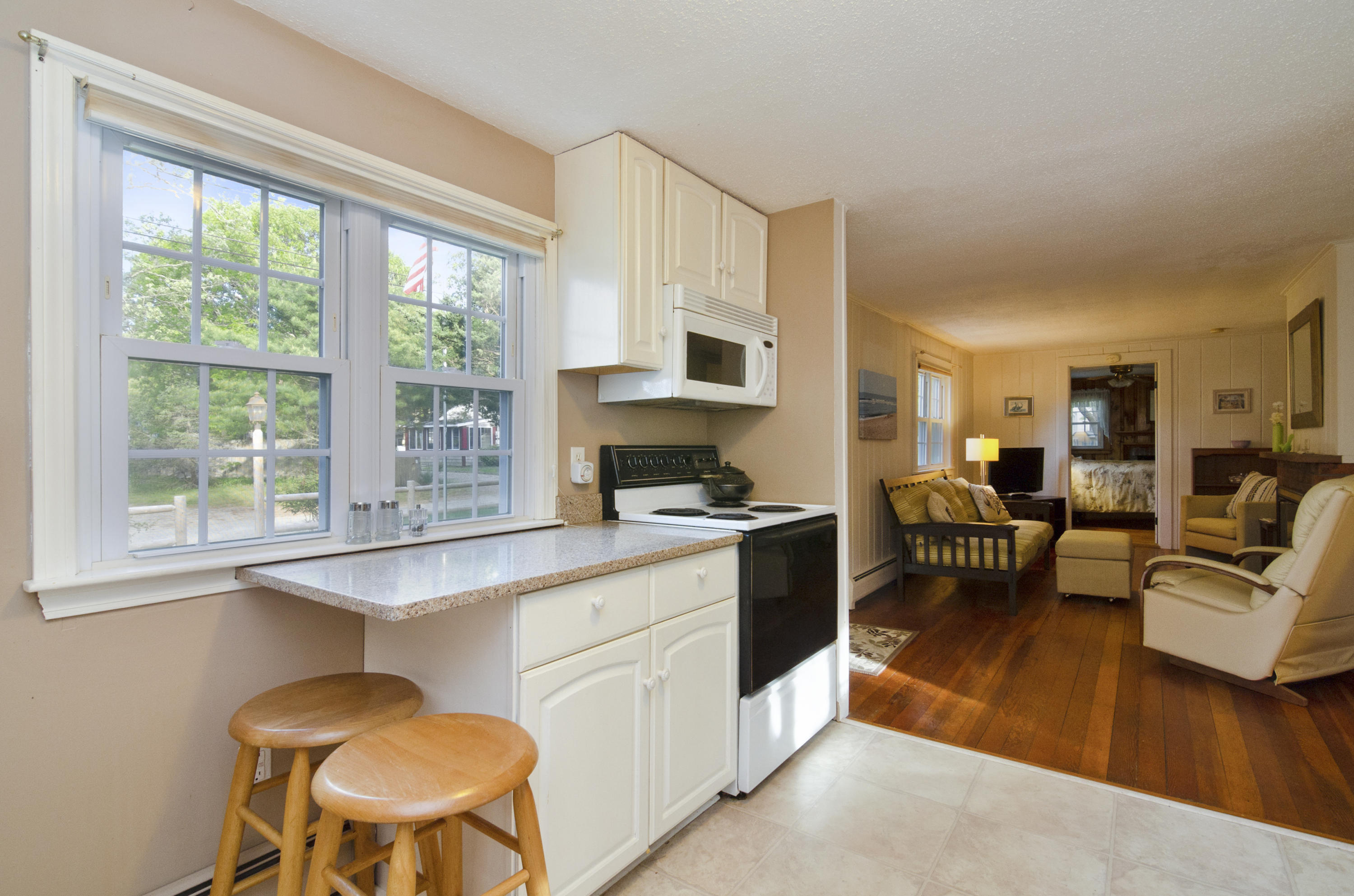 23 Skippers Way Brewster, MA 02631 - Photo 10 of 27 a living room with furniture a dining table and a large window