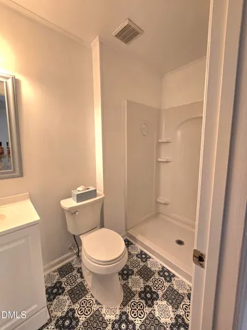 a white toilet sitting next to a bathroom sink