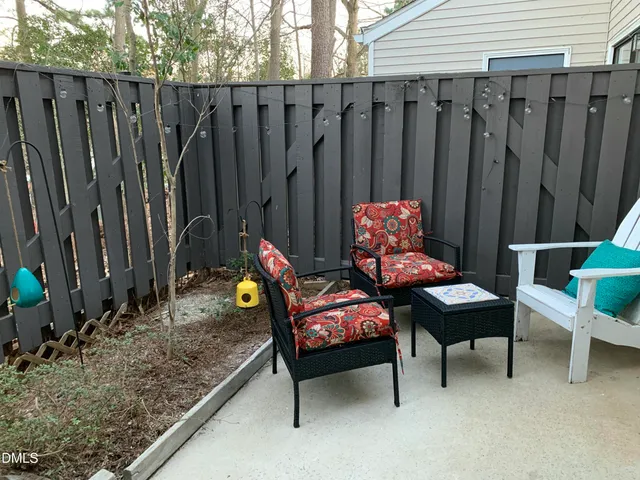 a backyard of a house with chairs and a table
