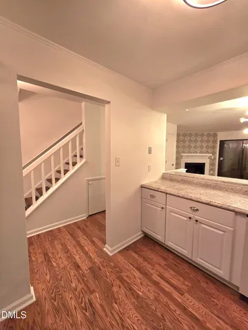 a spacious bathroom with a granite countertop sink and a mirror
