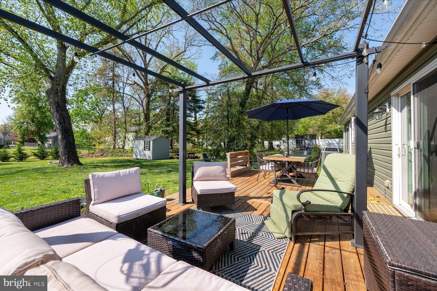 213 Old Magothy Bridge Road Pasadena, MD 21122 - Photo 21 of 31 a view of a patio with couches table and chairs with a yard