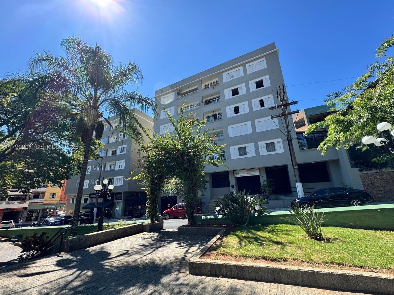 a view of a building with a yard and plants
