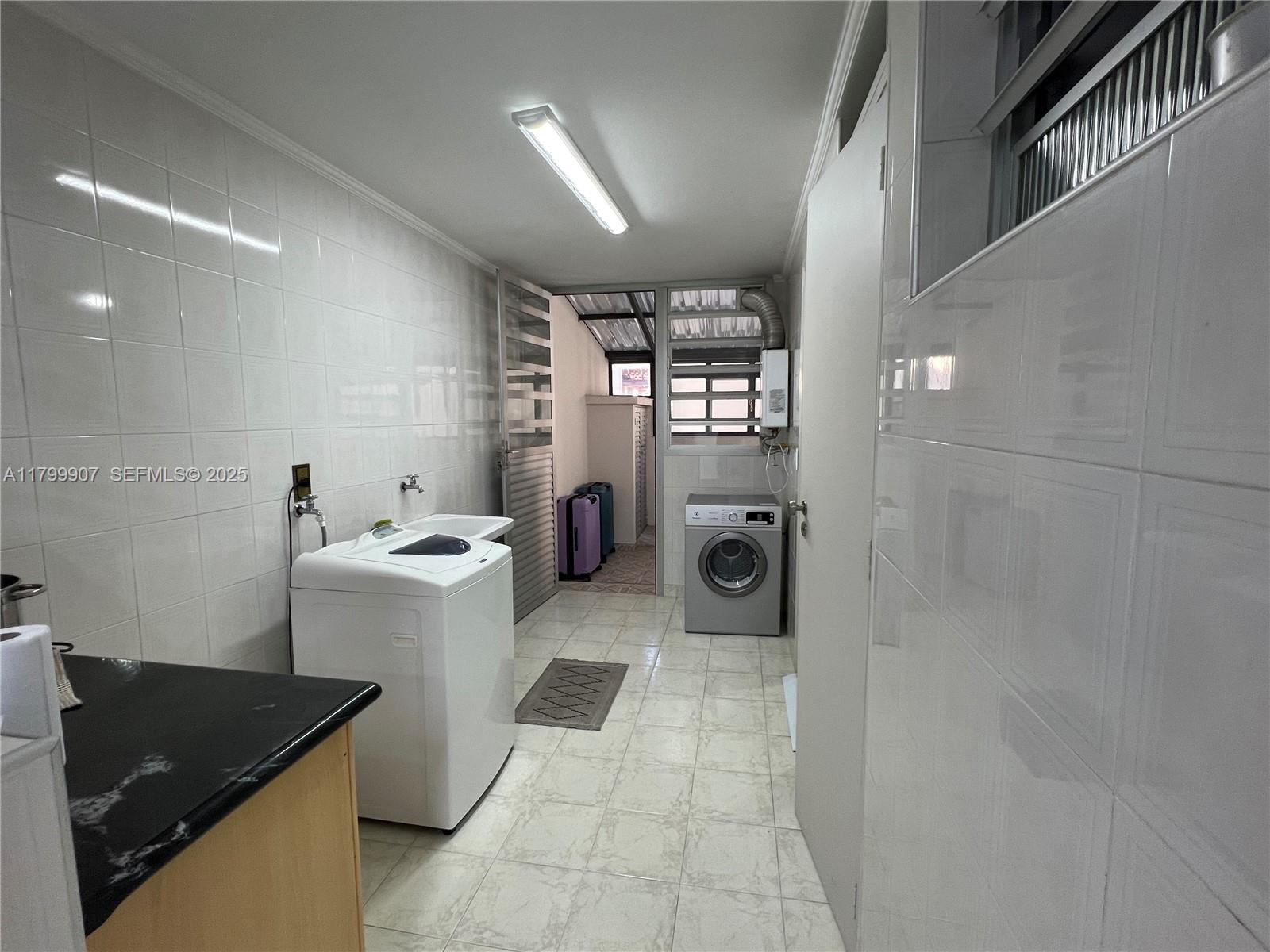 undefined, SP 13930 - Photo 18 of 26 a bathroom with a sink a washer and dryer