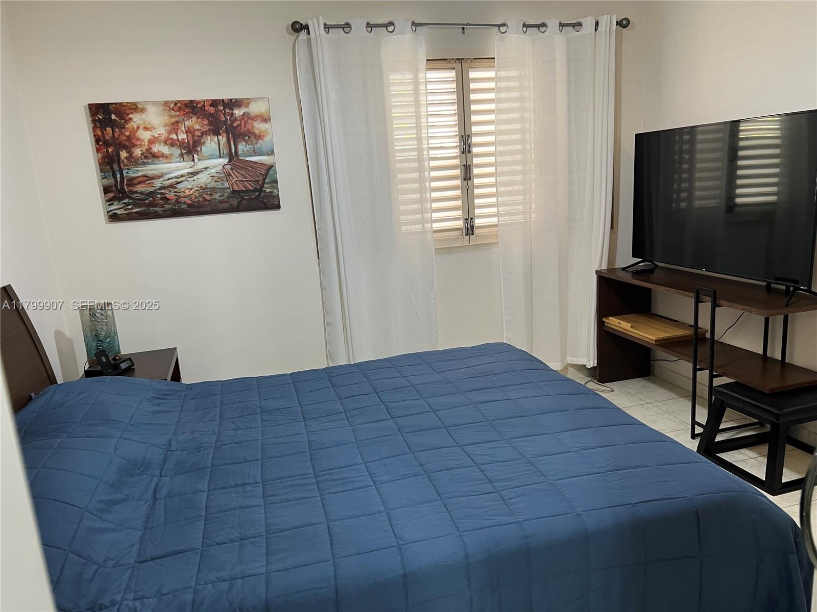 undefined, SP 13930 - Photo 21 of 26 a bedroom with a bed and a flat screen tv