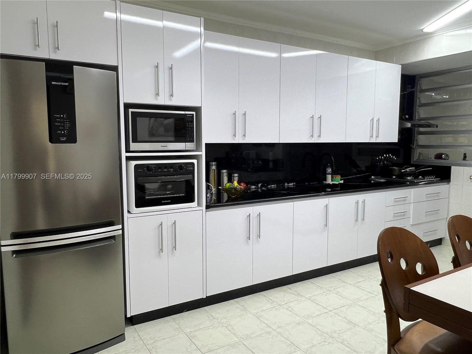 undefined, SP 13930 - Photo 8 of 26 a kitchen with stainless steel appliances a refrigerator a stove a microwave and cabinets