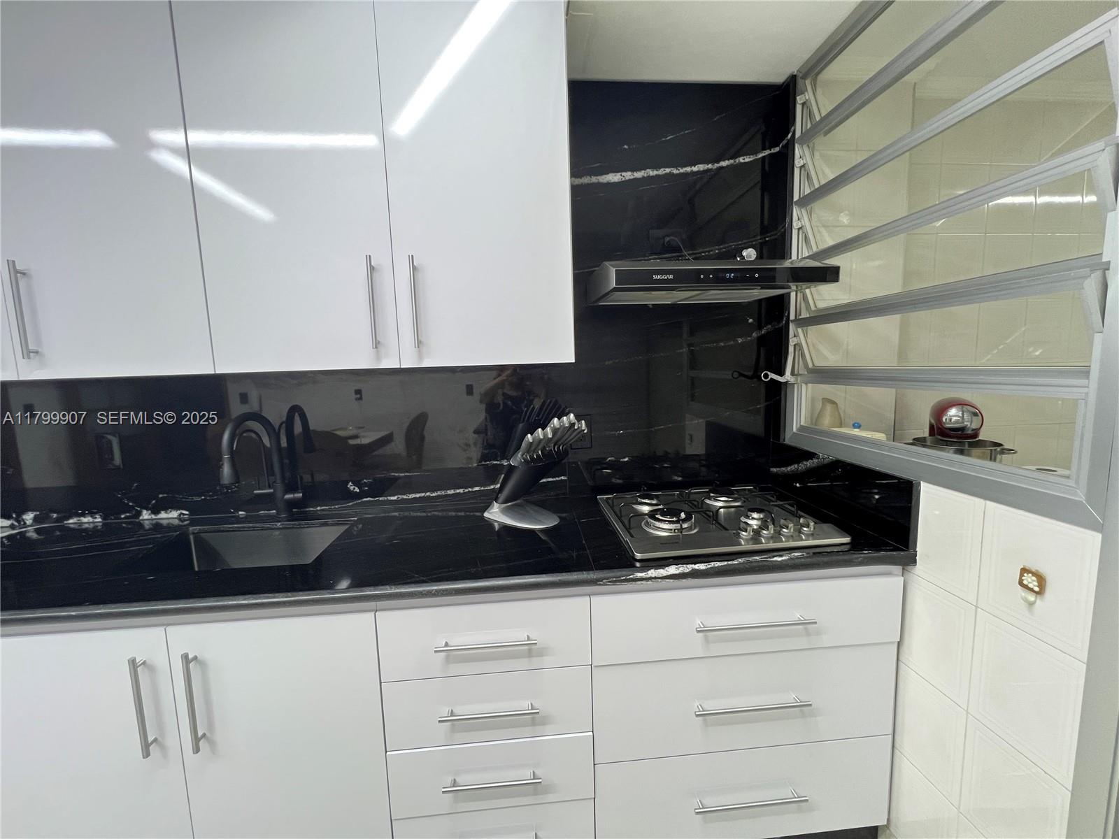 undefined, SP 13930 - Photo 9 of 26 a kitchen with a stove and cabinets